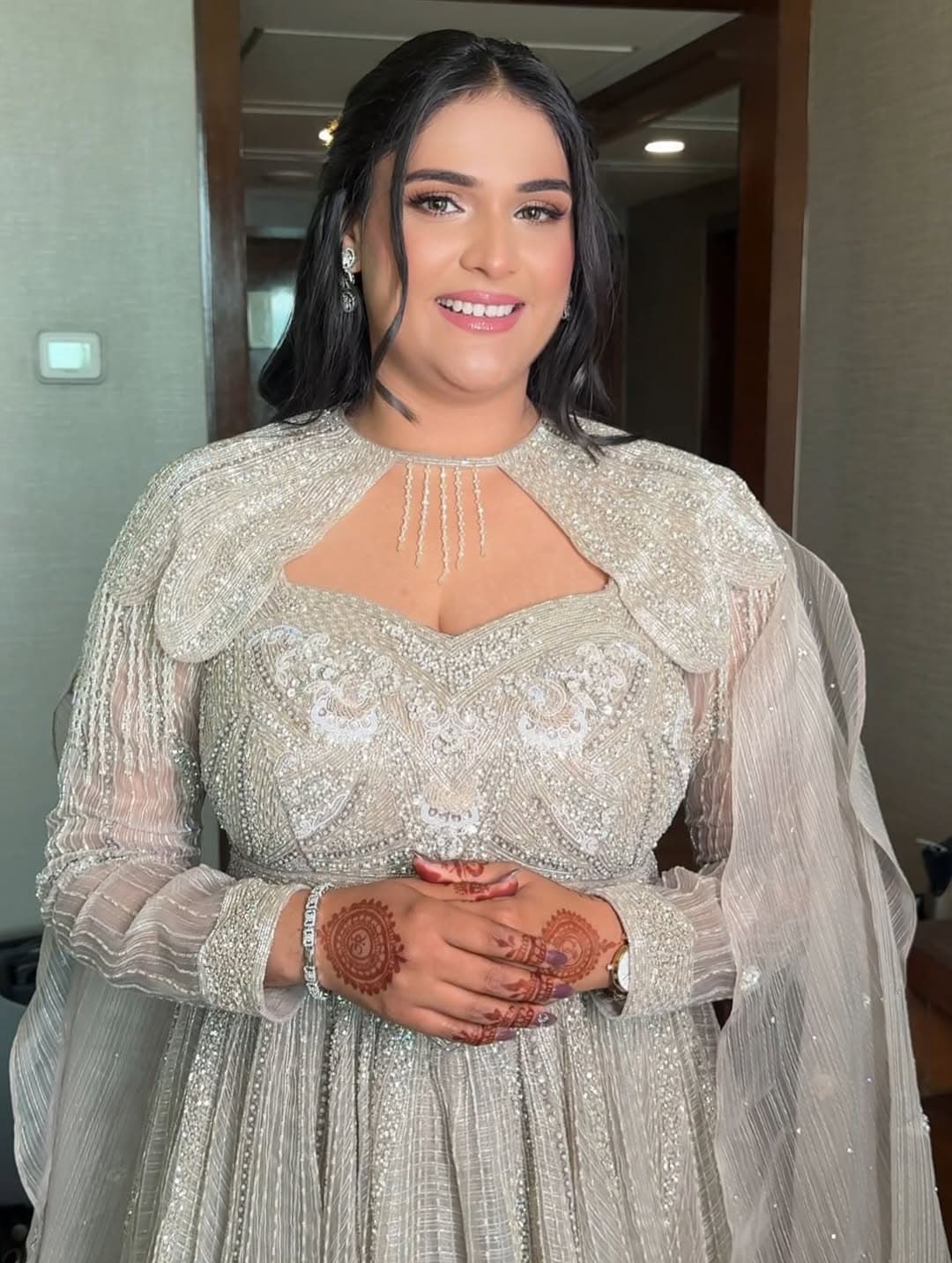 Reception portrait in a silver draped saree gown with crystal detailing and soft glam bridal styling